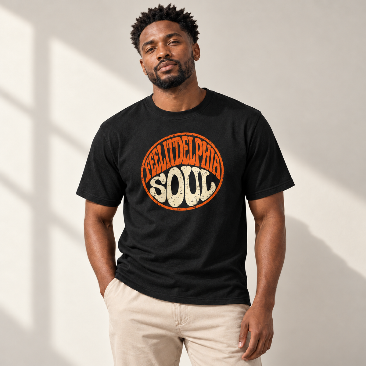 Model wearing the black FEELITDELPHIA SOUL graphic T-shirt